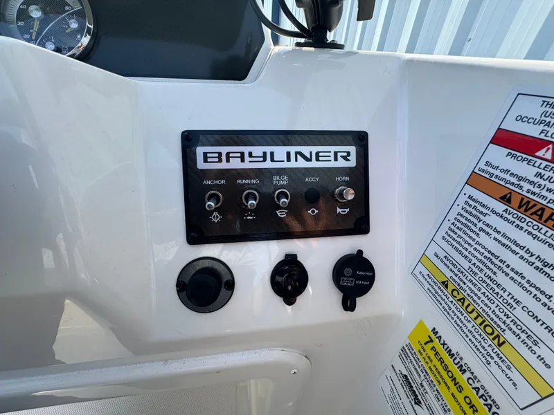 Slide: The Image of Control panel of 2022 Bayliner Element M17 boat with switches and safety warnings. - 12