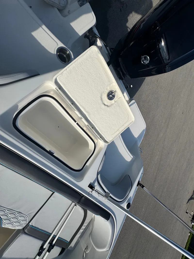 Slide: The Image of 2022 Bayliner Element M17 boat interior with open storage compartment and seating. - 15