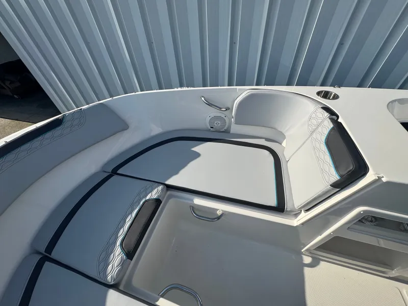 Slide: The Image of 2022 Bayliner Element M17 boat interior with cushioned seating and speaker. - 3