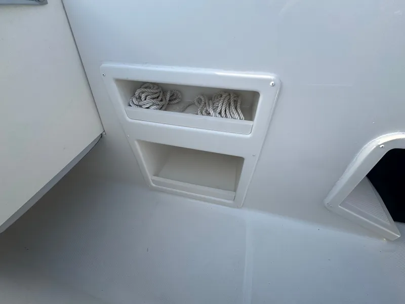 Slide: The Image of Storage compartment with ropes on a 2022 Bayliner Element M17 boat. - 7