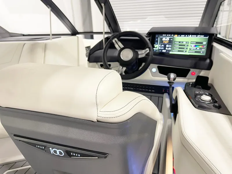 Slide: The Image of Interior of 2025 Nautique Super Air Nautique G23 boat with modern dashboard and controls. - 8