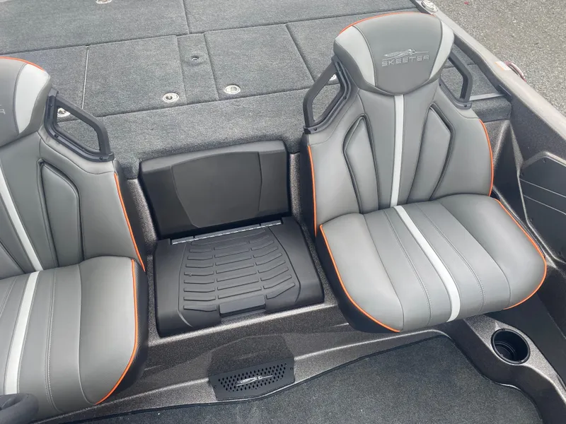 Slide: The Image of 2026 Skeeter ZXE 21 boat seats with gray upholstery and orange accents. - 16