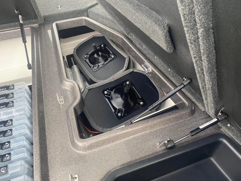 Slide: The Image of Storage compartments in a 2026 Skeeter ZXE 21 boat, featuring organized tackle boxes. - 20