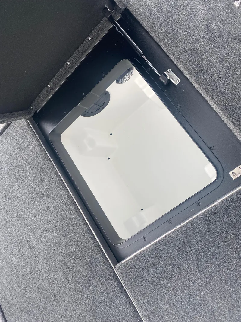 Slide: The Image of Storage compartment in 2026 Skeeter ZXE 21 boat, featuring a sleek, carpeted interior design. - 22
