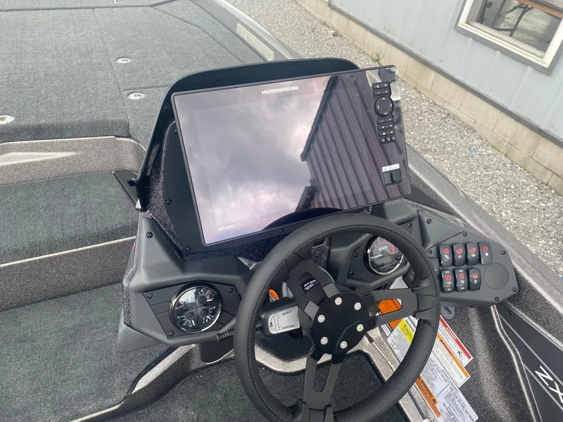 Slide: The Image of 2026 Skeeter ZXE 21 boat dashboard with steering wheel and advanced navigation display. - 9