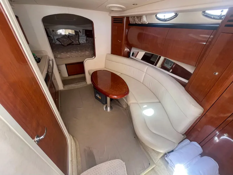 Slide: The Image of Interior of 2003 Sea Ray 360 Sundancer yacht with elegant seating and wooden finishes. - 13