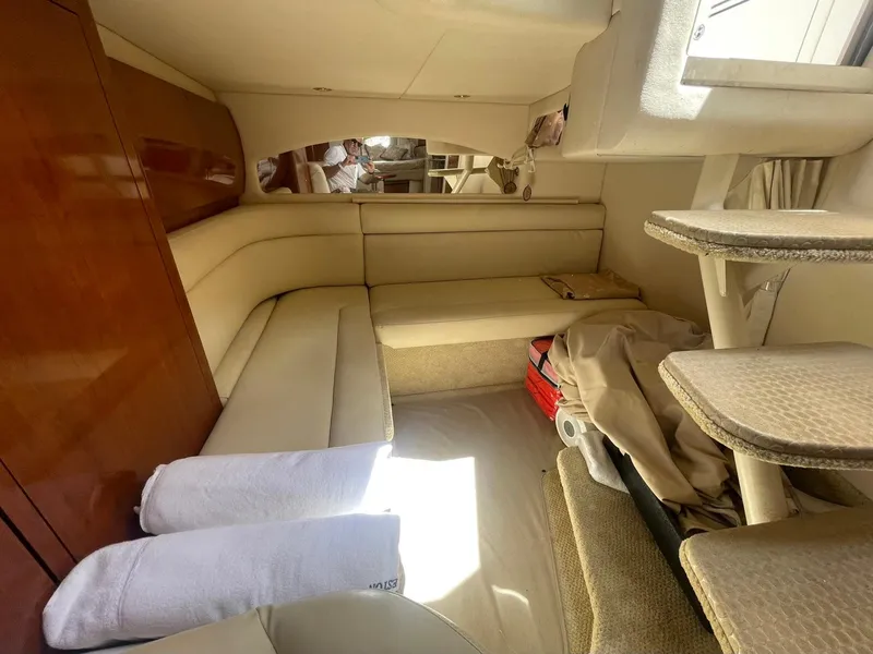 Slide: The Image of Interior of 2003 Sea Ray 360 Sundancer yacht with beige seating and wooden accents. - 20