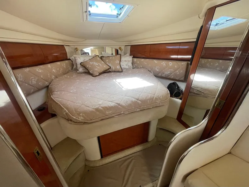 Slide: The Image of Luxurious cabin interior of 2003 Sea Ray 360 Sundancer with plush bedding and elegant wood finishes. - 21