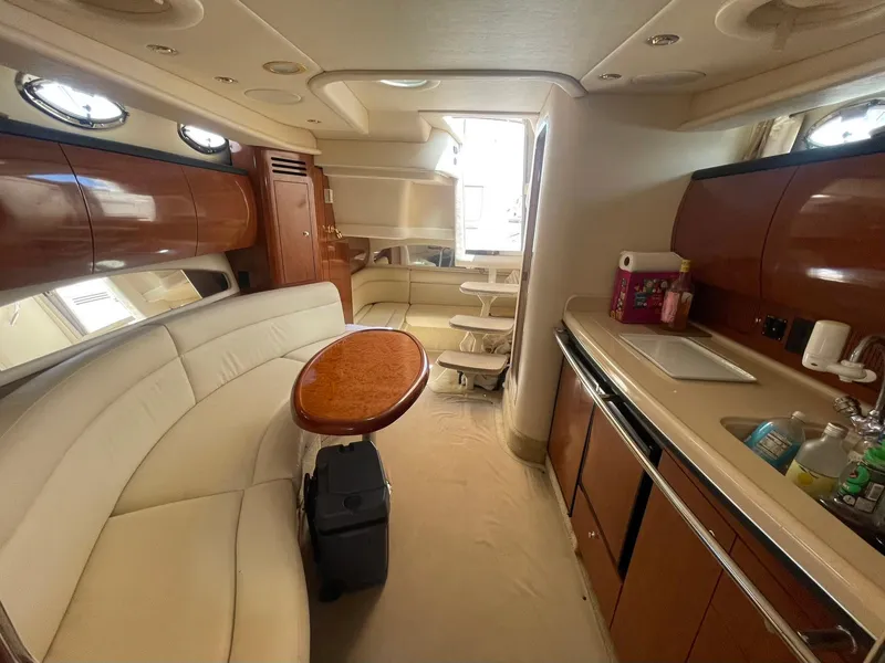 Slide: The Image of Luxurious interior of 2003 Sea Ray 360 Sundancer yacht with elegant seating and kitchenette. - 23