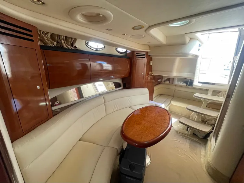 Slide: The Image of Interior of 2003 Sea Ray 360 Sundancer with elegant seating and wooden cabinetry. - 25