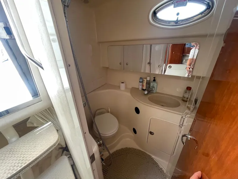 Slide: The Image of 2003 Sea Ray 360 Sundancer bathroom with shower, sink, and storage cabinets. - 27