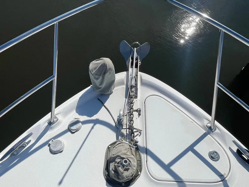 Slide: The Image of Bow of 2003 Sea Ray 360 Sundancer with anchor and railings, reflecting sunlight on water. - 31