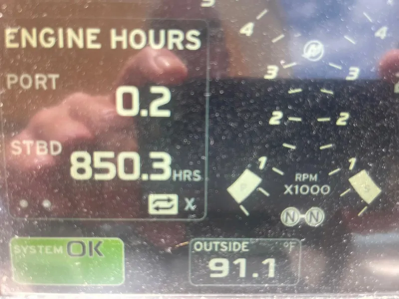 Slide: The Image of Close-up of 2003 Sea Ray 360 Sundancer engine hours display, showing 850.3 hours and 91.1°F outside. - 32
