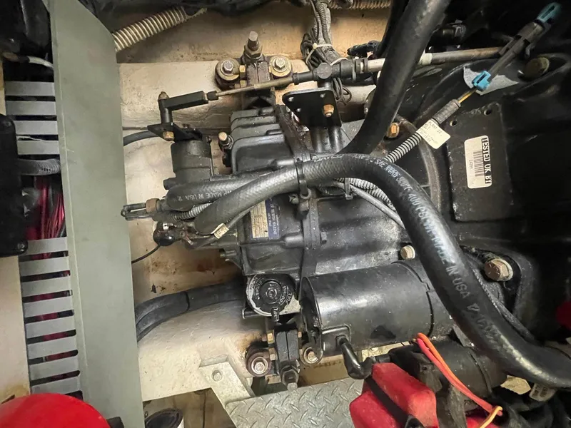Slide: The Image of Engine compartment of a 2003 Sea Ray 360 Sundancer boat, showing mechanical components and hoses. - 36