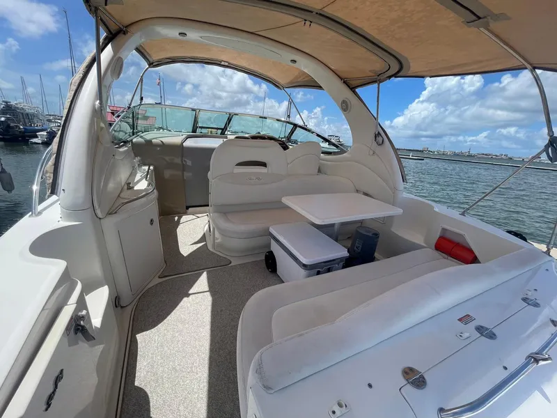 Slide: The Image of 2003 Sea Ray 360 Sundancer yacht interior with seating, table, and ocean view. - 5