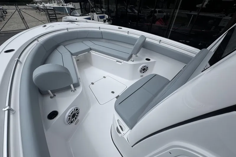 Slide: The Image of 2026 Sportsman Open 232 Center Console boat interior with cushioned seating and speakers. - 10