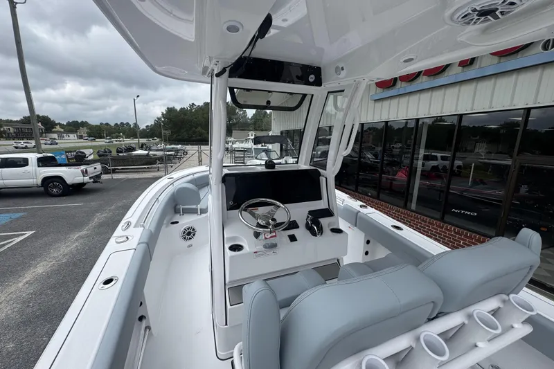 Slide: The Image of 2026 Sportsman Open 232 Center Console boat interior with modern helm and seating. - 11