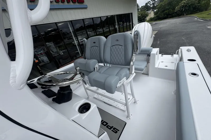 Slide: The Image of 2026 Sportsman Open 232 Center Console boat interior with modern seating and steering wheel. - 12