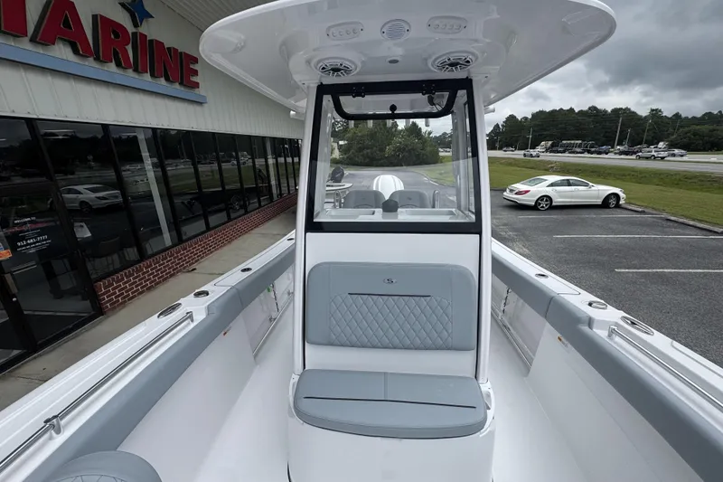 Slide: The Image of 2026 Sportsman Open 232 Center Console boat at dealership, showcasing sleek design and seating. - 13