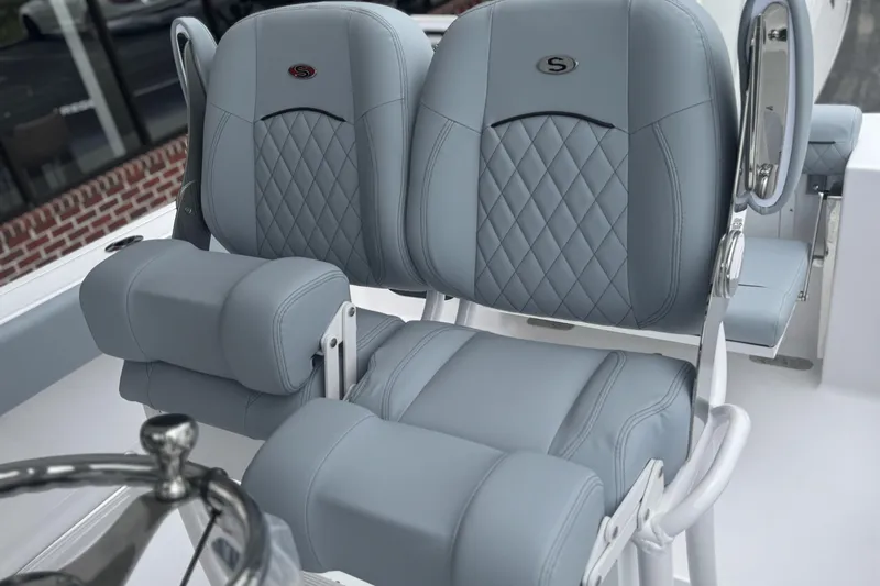 Slide: The Image of 2026 Sportsman Open 232 Center Console boat seats with diamond stitching and armrests. - 17