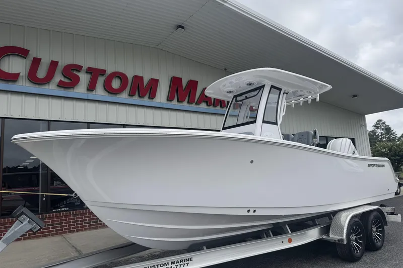 Slide: The Image of 2026 Sportsman Open 232 Center Console boat displayed at Custom Marine dealership. - 4