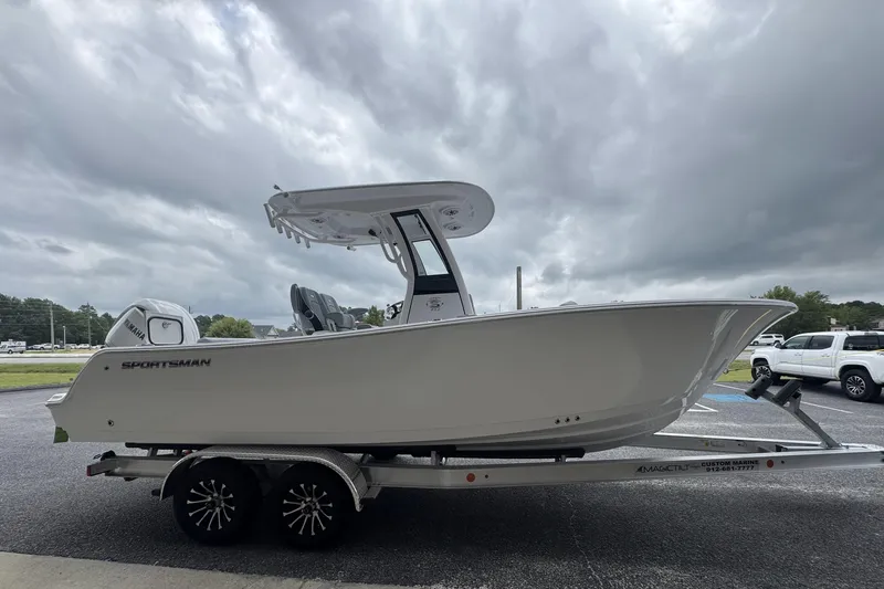 Slide: The Image of 2026 Sportsman Open 232 Center Console boat on trailer under cloudy sky. - 5