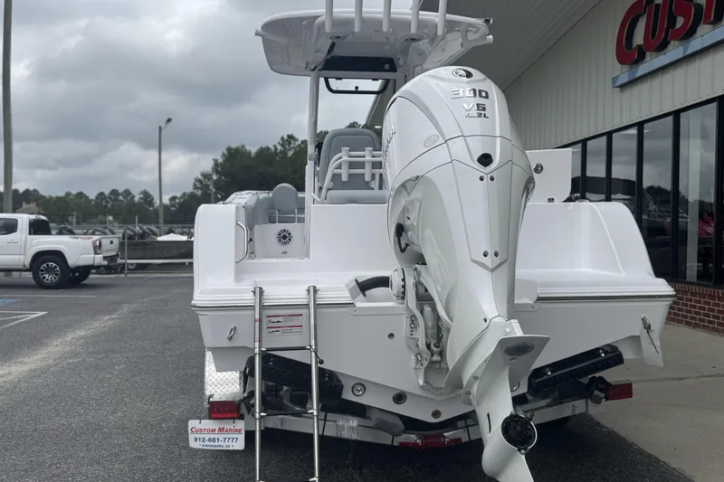 Slide: The Image of 2026 Sportsman Open 232 Center Console boat with Yamaha 300 V6 engine, parked outside dealership. - 8