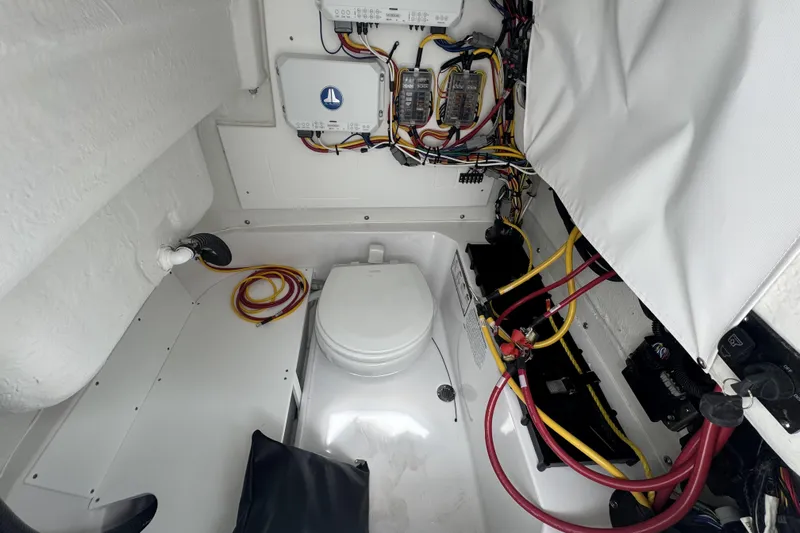 Slide: The Image of 2026 Sportsman Open 232 Center Console interior with wiring and marine toilet. - 9