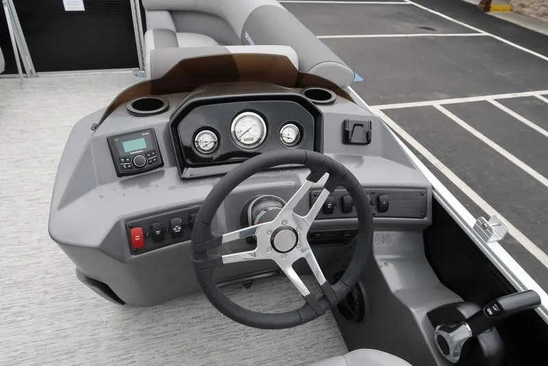 Slide: The Image of 2025 Bennington S L-Bench 21 SLJ boat dashboard with steering wheel and gauges. - 12