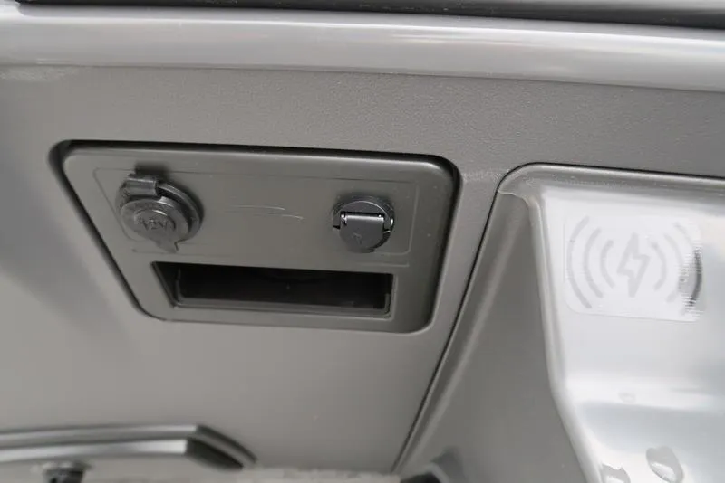 Slide: The Image of 2025 Bennington S L-Bench 21 SLJ dashboard with power outlets and wireless charging pad. - 14