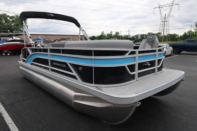 Slide: The Image of 2025 Bennington S L-Bench 21 SLJ pontoon boat in parking lot. - 3