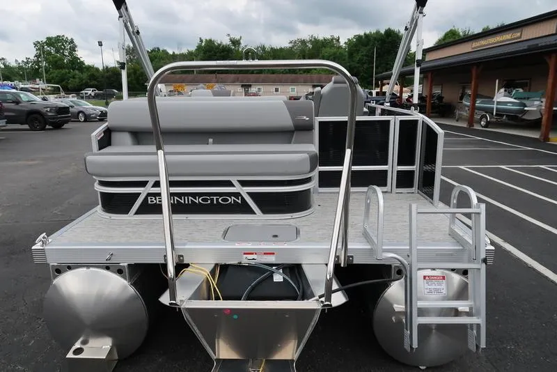 Slide: The Image of 2025 Bennington S L-Bench 21 SLJ pontoon boat, rear view with seating and ladder. - 4
