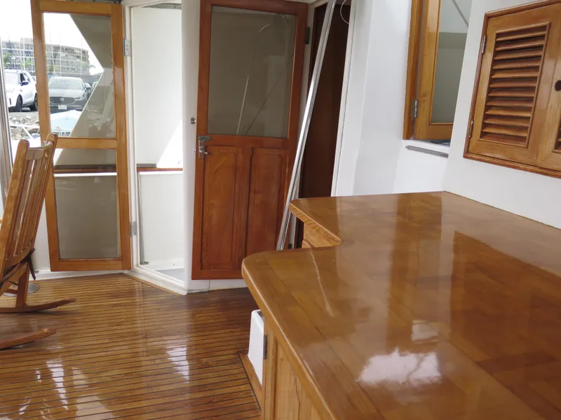 Slide: The Image of 1985 CHB Flush Deck Aftcabin interior with polished wood surfaces and doors. - 11