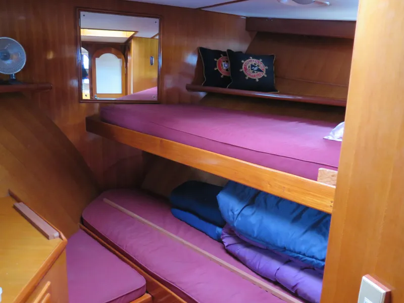 Slide: The Image of 1985 CHB Flush Deck Aftcabin interior with bunk beds and wooden paneling. - 12
