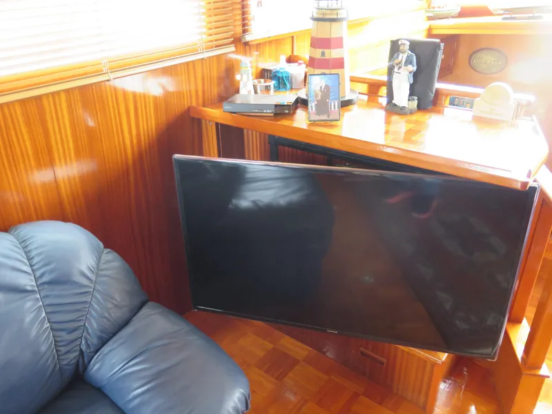 Slide: The Image of Luxurious 1985 CHB Flush Deck Aftcabin interior with TV, leather chair, and nautical decor. - 19