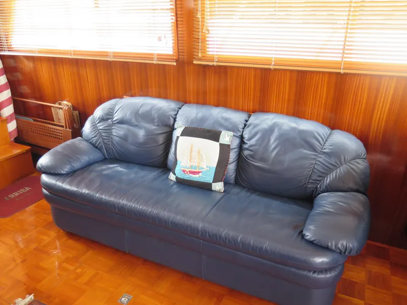 Slide: The Image of Blue leather sofa with nautical-themed pillow in 1985 CHB Flush Deck Aftcabin interior. - 20