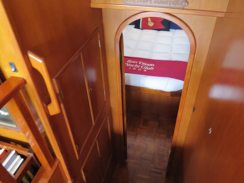 Slide: The Image of 1985 CHB Flush Deck Aftcabin interior with wooden finish and cozy bedroom view. - 23