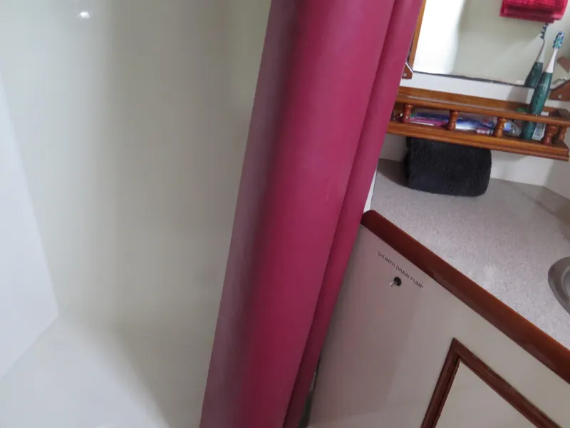 Slide: The Image of Interior of 1985 CHB Flush Deck Aftcabin with shower and red curtain. - 26