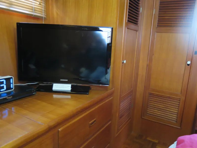 Slide: The Image of 1985 CHB Flush Deck Aftcabin interior with TV, wooden cabinets, and digital clock. - 27