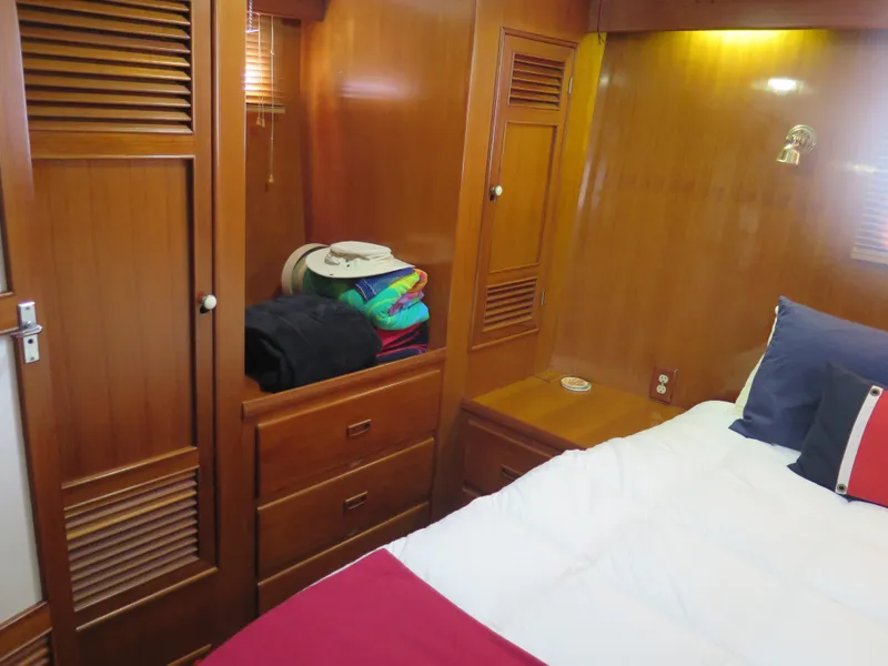 Slide: The Image of 1985 CHB Flush Deck Aftcabin interior with wooden cabinetry and cozy bedding. - 28