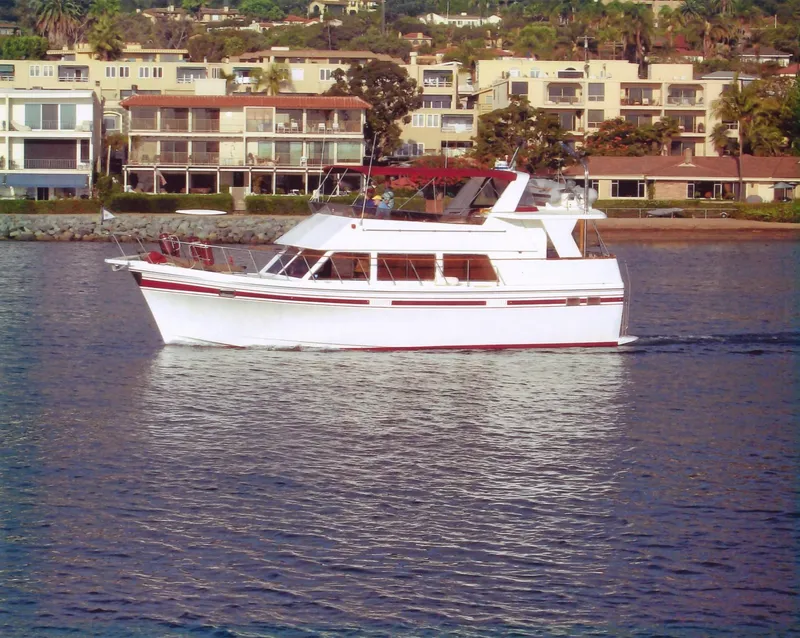 Slide: The Image of 1985 CHB Flush Deck Aftcabin yacht cruising near waterfront homes. - 35