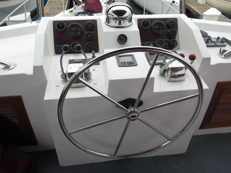 Slide: The Image of 1985 CHB Flush Deck Aftcabin helm with steering wheel and control panels. - 4