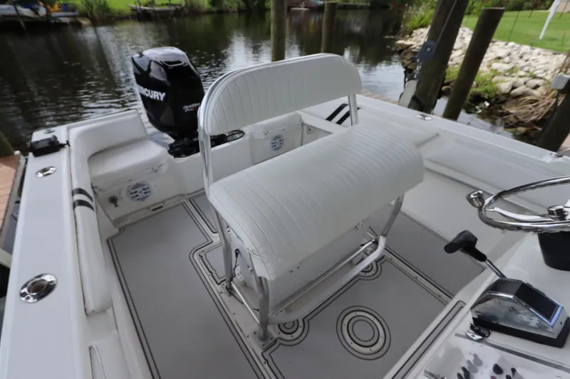 Slide: The Image of 2001 Fountain 25CC boat interior with white seating and Mercury outboard motor. - 12
