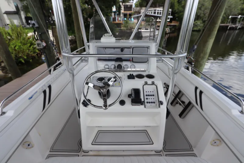 Slide: The Image of Center console of a 2001 Fountain 25CC boat with steering wheel and controls. - 13