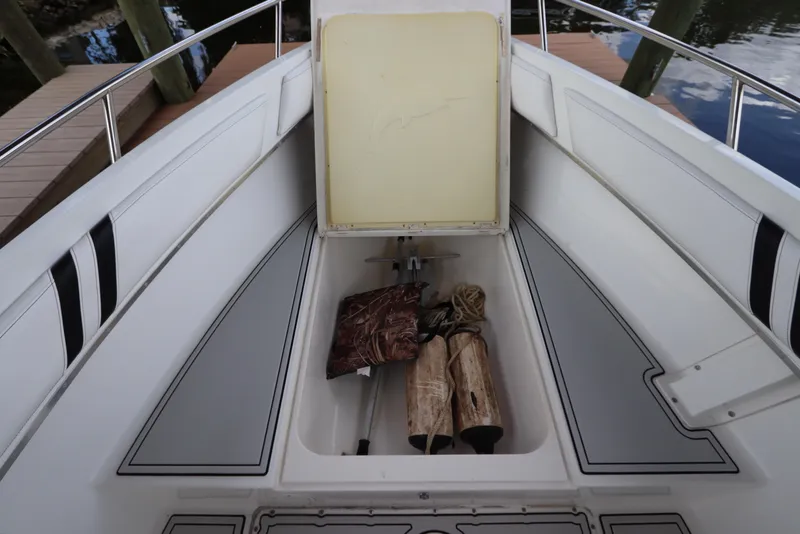 Slide: The Image of Open storage compartment on 2001 Fountain 25CC boat with ropes and fenders. - 22