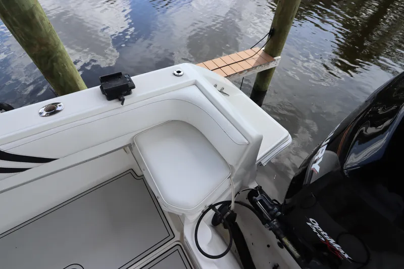 Slide: The Image of 2001 Fountain 25CC boat stern with seating and Mercury outboard motor. - 7
