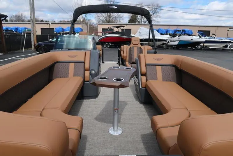 Slide: The Image of 2025 Bennington M Quad Bench 24 MFB pontoon boat with luxurious seating and modern design. - 2