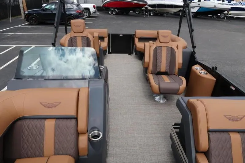 Slide: The Image of 2025 Bennington M Quad Bench 24 MFB pontoon boat with luxurious seating and modern design. - 21