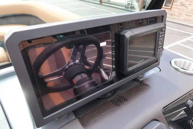 Slide: The Image of Dashboard of 2025 Bennington M Quad Bench 24 MFB with steering wheel reflection. - 22