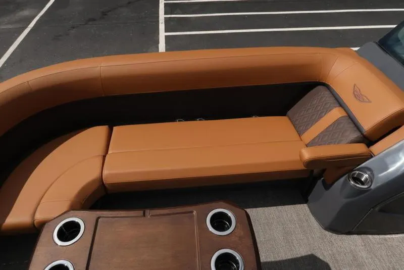 Slide: The Image of Luxurious seating on 2025 Bennington M Quad Bench 24 MFB boat, featuring cup holders and elegant design. - 26